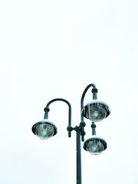 Low angle view of light bulb over white background