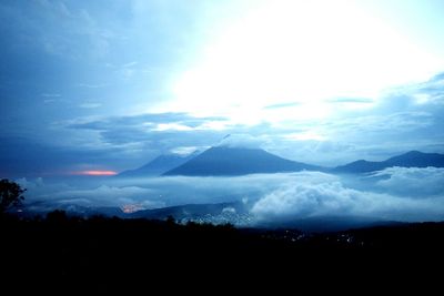 Silhouette of mountain against cloudy sky