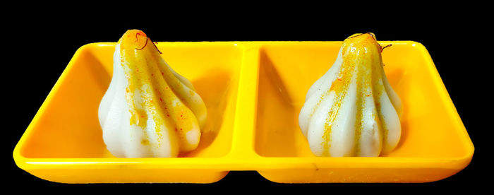 Close-up of sushi against black background