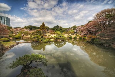 Scenic view of lake by buildings against sky