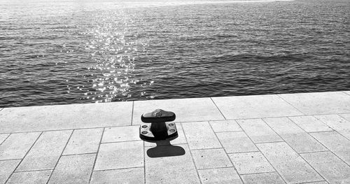 Black and white rippled sea and wharf with clear 