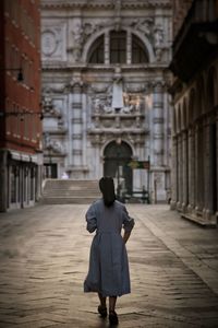 Rear view of woman walking on street