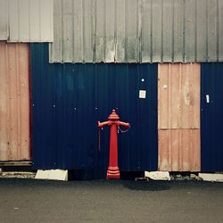 Fire hydrant on road against huts