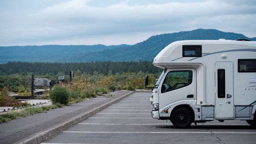 Camping car on road against mountain range
