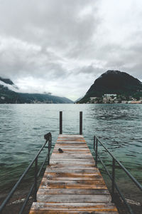 Pier over lake against sky