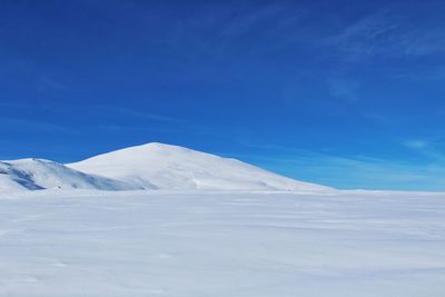 Snowcapped mountains against blue sky