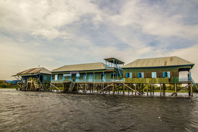 Built structure on beach by building against sky