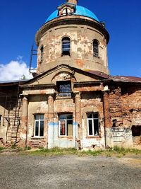 Low angle view of old building against blue sky