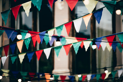 Close-up of colorful buntings hanging in city