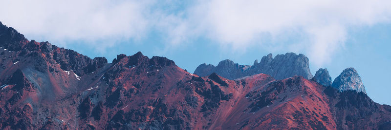 Panoramic view of majestic mountains against sky during winter