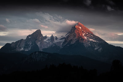 Scenic view of snowcapped mountains against sky during sunset