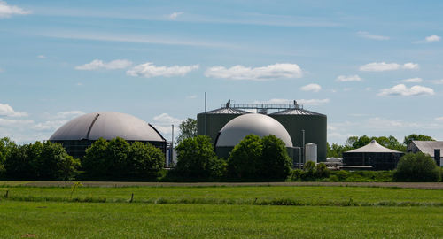 Built structure on field against sky