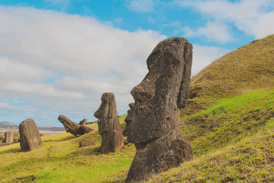 Rock formations on field against sky