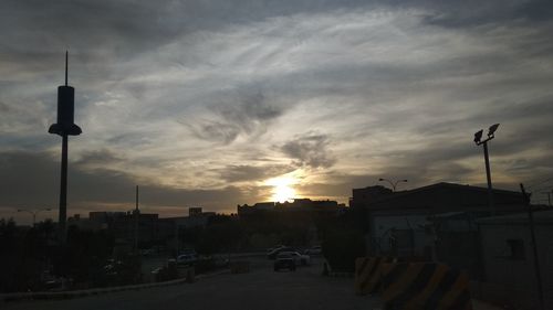 Street light in city against sky