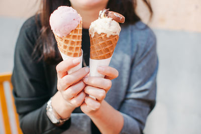 Midsection of woman holding gelato ice cream cones
