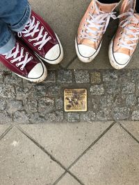 Low section of woman standing on tiled floor