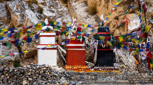 Multi colored umbrellas on rock against building