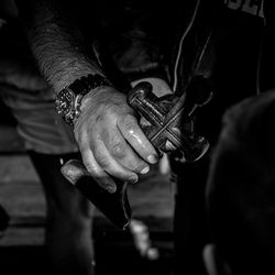 Midsection of man holding cross while standing in church