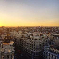 High angle view of city buildings against sky during sunset