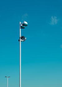 Low angle view of street light against blue sky