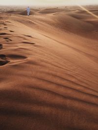 Surface level of sand dunes in desert against the sky