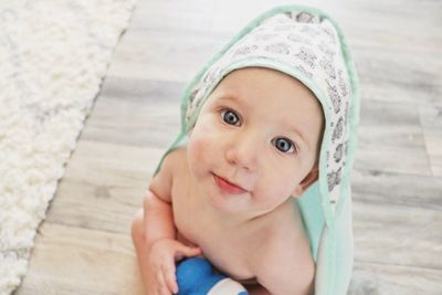 A small baby  boy happily looking at the camera after a bath. 