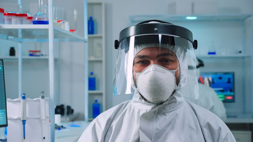 Portrait of scientist wearing face mask at laboratory