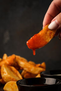 Cropped hand of person preparing food