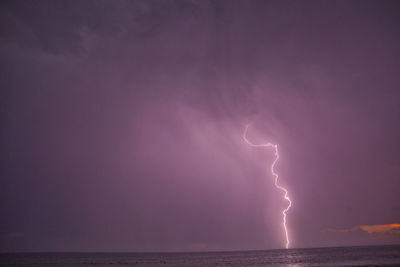 Lightning in sky over sea