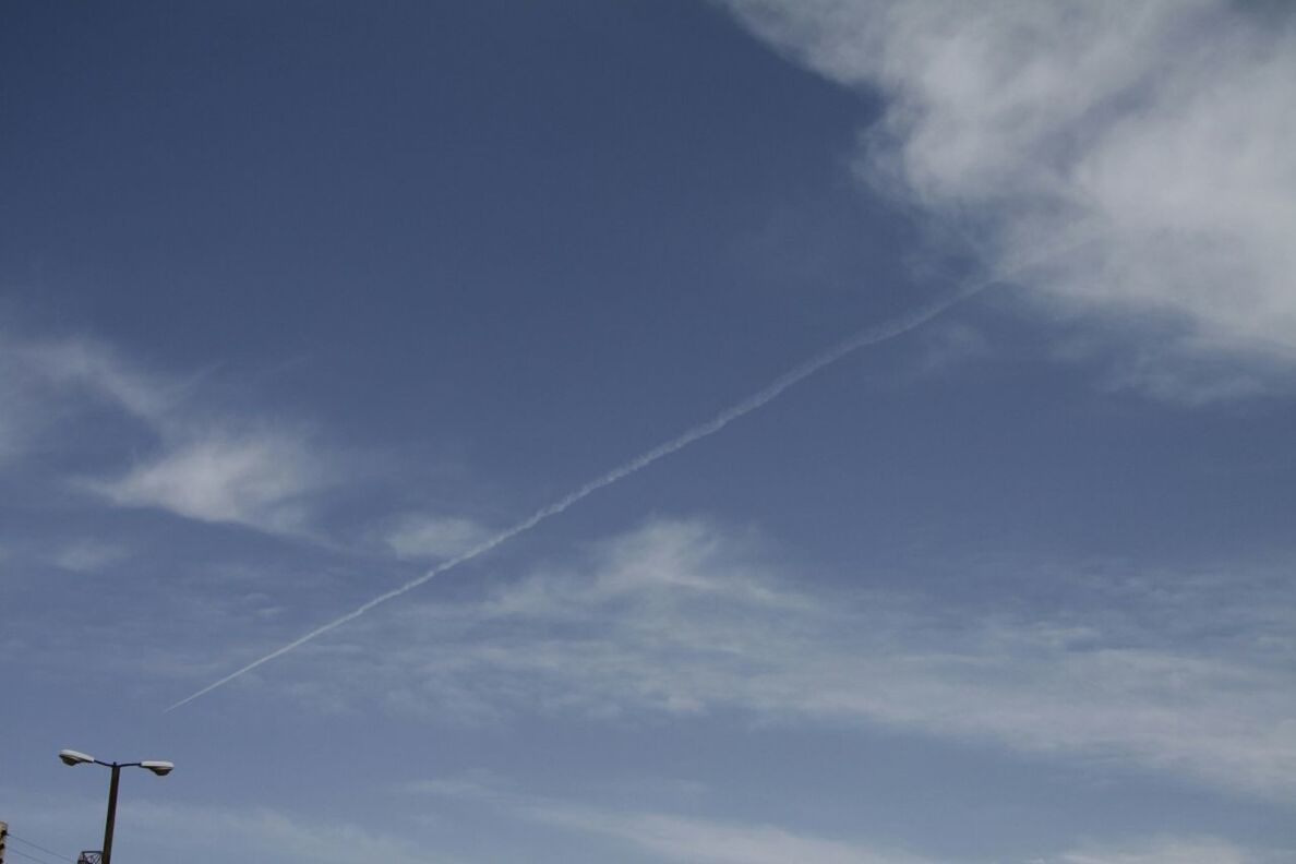 low angle view, sky, blue, cloud - sky, tranquility, cloud, nature, beauty in nature, cloudy, scenics, street light, outdoors, day, tranquil scene, no people, vapor trail, electricity, power line, high section, cable