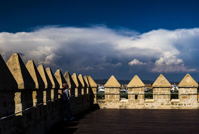 Pier amidst buildings against sky