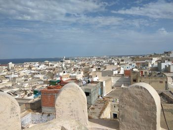 View of town against cloudy sky