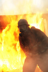 Firefighter in front of building on fire