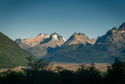 Scenic view of snowcapped mountains against clear blue sky