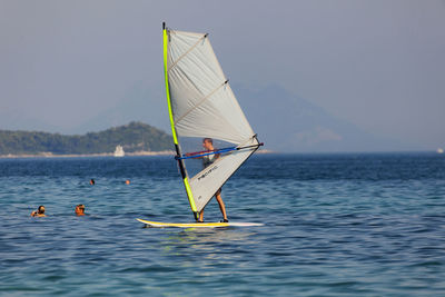 Sailboat in sea against sky