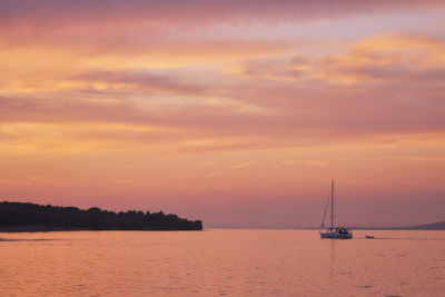 Scenic view of calm sea against cloudy sky