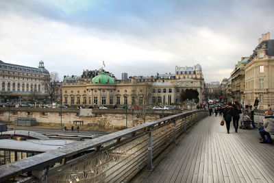 People in city against sky