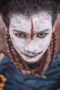 Close-up portrait of man in face paint