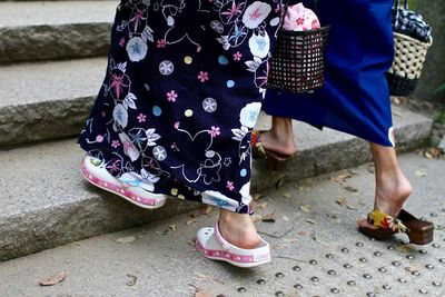 Low section of people standing on street