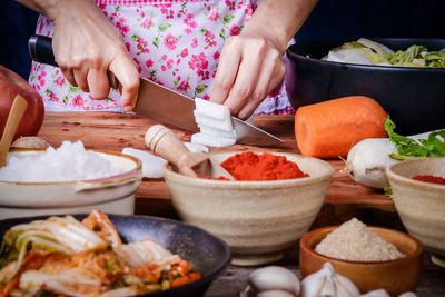 Midsection of man preparing food on table