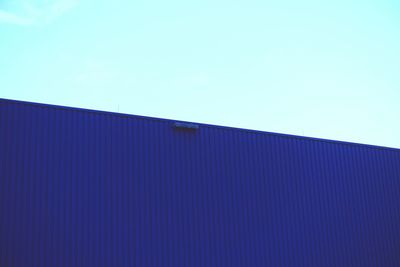 Low angle view of built structure against clear blue sky