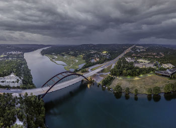 High angle view of river by city against sky