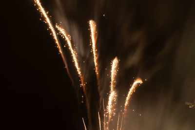 Low angle view of firework display at night