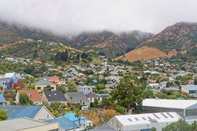 Houses in town against sky