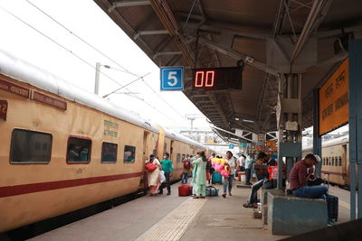 People walking on railroad station platform