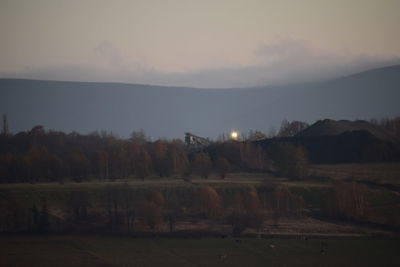 Scenic view of field against sky at sunset