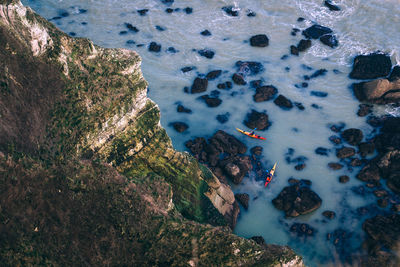 High angle view of rocks on sea shore