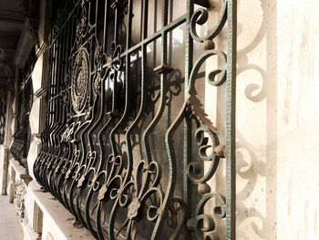 Close-up of metal gate against wall