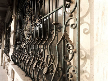 Close-up of metal gate against wall