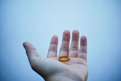 Close-up of human hand against blue background